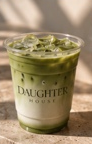 Green matcha drink in a DaughterHouse branded cup