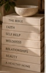 Stack of books representing faith, self-help, wellness, relationships, beauty, and home